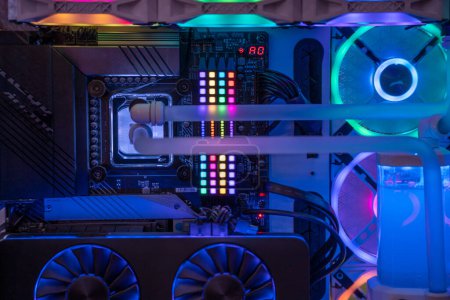 Photo for Shot of overclocked CPU computer cabinet with water liquid cooled processors and RGB red green blue lighting with metal pipes running India - Royalty Free Image