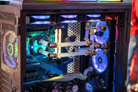 Photo for Shot of overclocked CPU computer cabinet with water liquid cooled processors and RGB red green blue lighting with metal pipes running India - Royalty Free Image