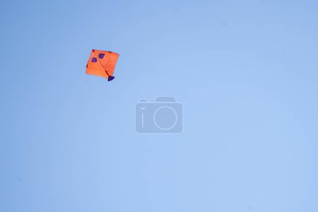 Photo for Red kite flying against blue sky on independence day in India in delhi 6 showing this popular celebration - Royalty Free Image