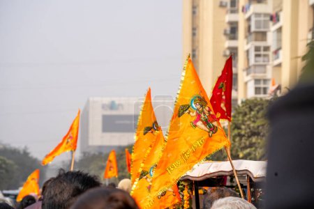 Photo for Gurgaon, Delhi, India - 22nd Jan 2024: Crowd of people walking on Shobha yatra walk carrying flag celebrating the Pran Pratishtha consecration of Ram mandir temple massive celebration in India - Royalty Free Image