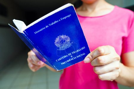 Photo for January 6, 2023, Brazil. In this photo illustration, a safe woman Work and Social Security Card (Carteira de Trabalho) seen displayed. It is the document that guarantees access to the rights of the Brazilian worker - Royalty Free Image