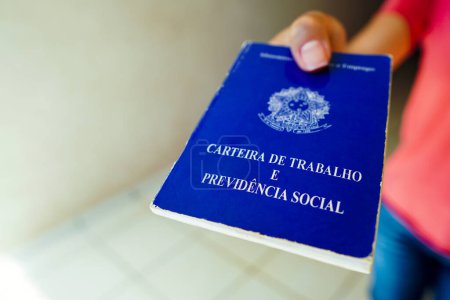 Photo for January 6, 2023, Brazil. In this photo illustration, a safe woman Work and Social Security Card (Carteira de Trabalho) seen displayed. It is the document that guarantees access to the rights of the Brazilian worker - Royalty Free Image
