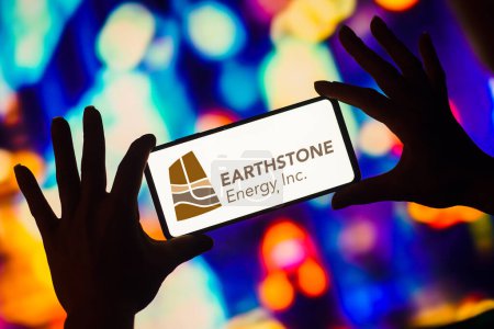 Photo for January 7, 2023, Brazil. In this photo illustration, the Earthstone Energy logo is displayed on a smartphone screen - Royalty Free Image