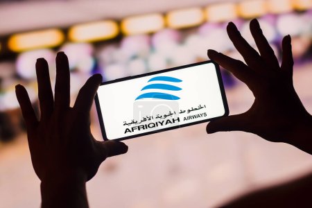 Photo for January 19, 2023, Brazil. In this photo illustration, the Afriqiyah Airways logo is displayed on a smartphone screen. It is a Libyan airline. It operates domestic flights between Tripoli and Benghazi and international flights to over 25 countries in - Royalty Free Image