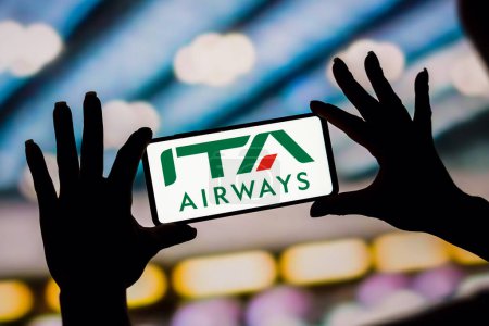 Photo for February 6, 2023, Brazil. In this photo illustration, the ITA Airways logo is displayed on a smartphone screen - Royalty Free Image