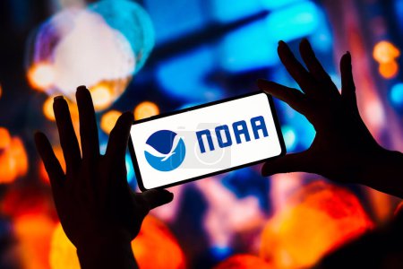 Photo for February 7, 2023, Brazil. In this photo illustration, the National Oceanic and Atmospheric Administration (NOAA) logo is displayed on a smartphone screen - Royalty Free Image