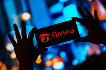 Photo for February 7, 2023, Brazil. In this photo illustration, the Garena logo is displayed on a smartphone screen - Royalty Free Image