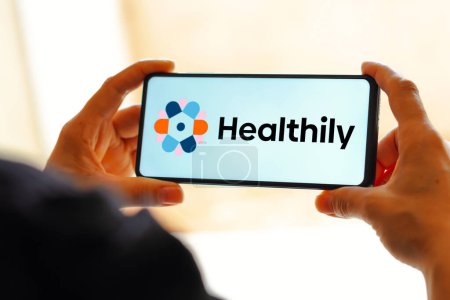 Photo for February 24, 2023, Brazil. In this photo illustration the Healthily logo seen displayed on a smartphone - Royalty Free Image