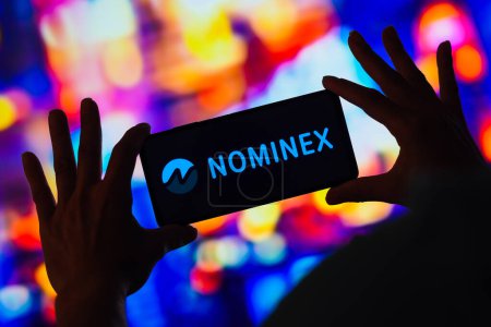 Foto de February 27, 2023, Brazil. In this photo illustration, the Nominex logo seen displayed on a smartphone - Imagen libre de derechos