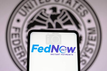Photo for March 17, 2023, Brazil. In this photo illustration the FedNow Service (Instant Payments) logo seen displayed on a smartphone and Federal Reserve System of the United States - Royalty Free Image