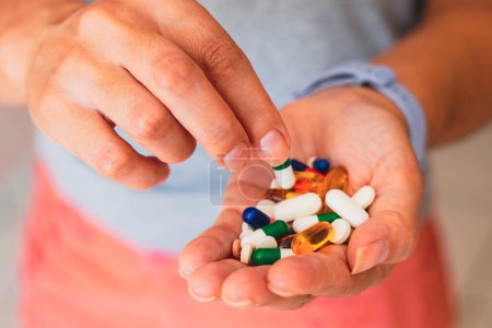 Photo for April 11, 2023, Brazil. In this photo illustration, a person holds several medicine pills in his hand - Royalty Free Image