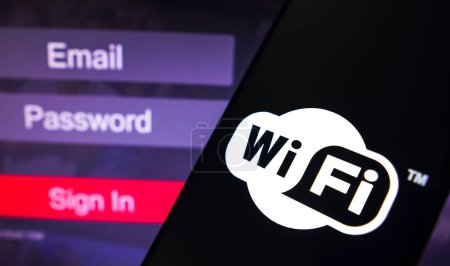 Photo for May 1, 2023, Brazil. In this photo illustration, the Wi-Fi logo is displayed on a smartphone screen, next to a login screen, with email, password and sign in - Royalty Free Image