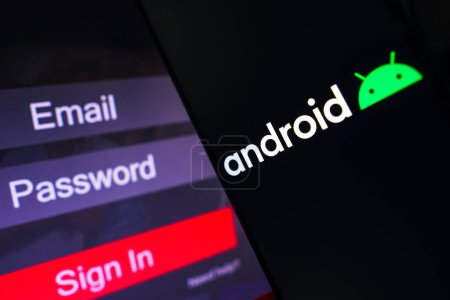 Photo for May 1, 2023, Brazil. In this photo illustration, the Android logo is displayed on a smartphone screen, next to a login screen, with email, password and sign in - Royalty Free Image