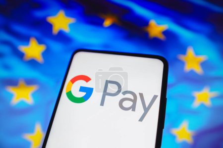 Photo for May 16, 2023, Brazil. In this photo illustration, the Google Pay logo is displayed on a smartphone screen and in the background, the flag of the European Union - Royalty Free Image