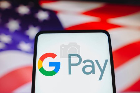 Photo for May 16, 2023, Brazil. In this photo illustration, the Google Pay logo is displayed on a smartphone screen and in the background, the flag of the United States of America - Royalty Free Image