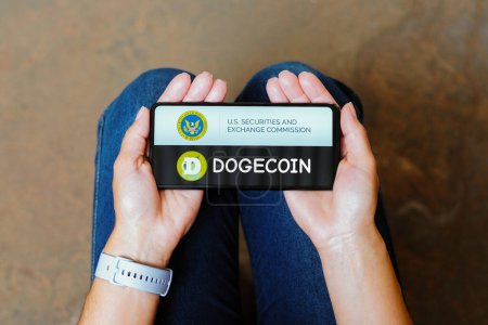 Photo for June 11, 2023, Brazil. In this photo illustration, the Securities and Exchange Commission (SEC) and Dogecoin logo is displayed on a smartphone screen - Royalty Free Image