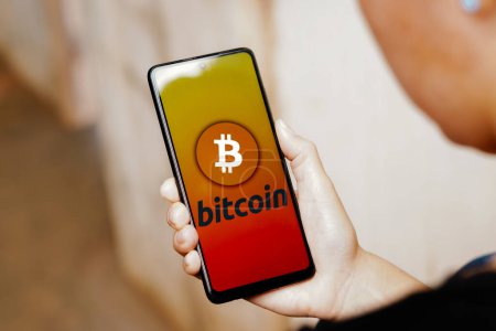 Photo for June 20, 2023, Brazil. In this photo illustration, the Bitcoin logo is displayed on a smartphone screen - Royalty Free Image