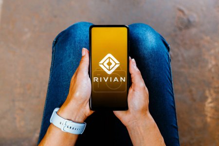 Photo for July 2, 2023, Brazil. In this photo illustration, the Rivian logo is displayed on a smartphone screen - Royalty Free Image