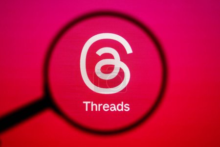 Photo for July 7, 2023, Brazil. In this photo illustration, a Threads app logo seen displayed on a computer screen through a magnifying glass - Royalty Free Image