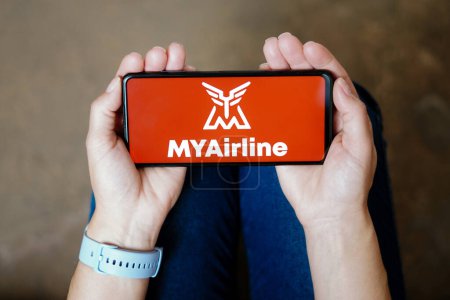 Téléchargez les photos : July 20, 2023, Brazil. In this photo illustration, the MYAirline logo seen displayed on a smartphone - en image libre de droit