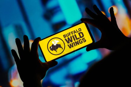 Photo for August 20, 2023, Brazil. In this photo illustration, the Buffalo Wild Wings (BWW) logo seen displayed on a smartphone - Royalty Free Image