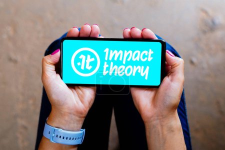 Photo for August 29, 2023, Brazil. In this photo illustration, the Impact Theory logo seen displayed on a smartphone - Royalty Free Image