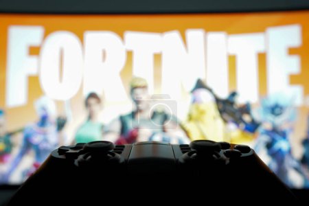Photo for November 1, 2023, Brazil. In this photo illustration, the Fortnite logo game is displayed on a computer screen, next to a gamepad - Royalty Free Image