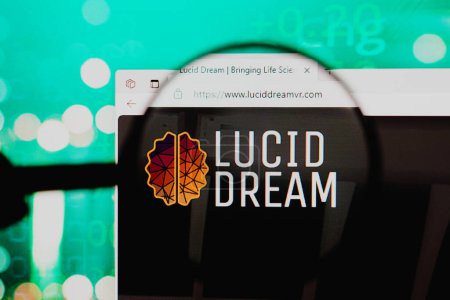 Photo for December 1, 2023, Brazil. In this photo illustration, the homepage of the Lucid Dream website seen on a computer screen through a magnifying glass - Royalty Free Image