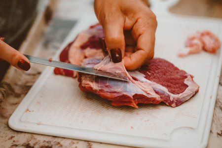 Photo for Fat from red meat is removed by the cook. Red meat has a huge amount of vitamins from complex B, E, K and zinc, iron, proteins - Royalty Free Image