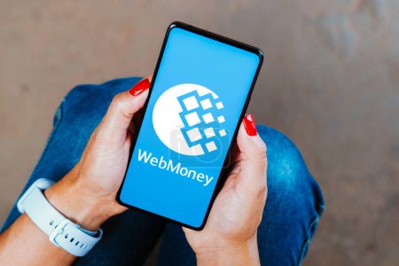 Photo for December 29, 2023, Brazil. In this photo illustration, the WebMoney logo is displayed on a smartphone screen - Royalty Free Image