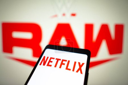 Photo for January 23, 2024, Brazil. In this photo illustration, the Netflix logo is displayed on a smartphone screen and WWE Raw logo in the background - Royalty Free Image