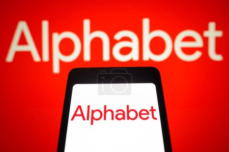 Photo for February 4, 2024, Brazil. In this photo illustration, the Alphabet Inc. logo is displayed on a smartphone screen and in the background - Royalty Free Image