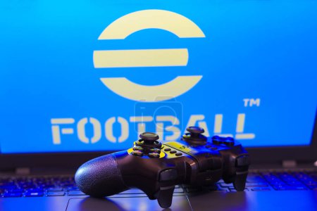 Photo for February 5, 2024, Brazil. In this photo illustration, the eFootball logo game is displayed on a computer screen, next to a gamepad - Royalty Free Image