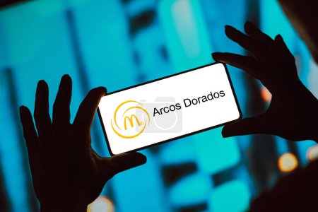 Photo for February 8, 2024, Brazil. In this photo illustration, the Arcos Dorados Holdings logo is displayed on a smartphone screen - Royalty Free Image