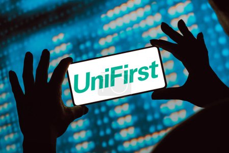 Photo for February 12, 2024, Brazil. In this photo illustration, the Unifirst Corporation logo is displayed on a smartphone screen - Royalty Free Image