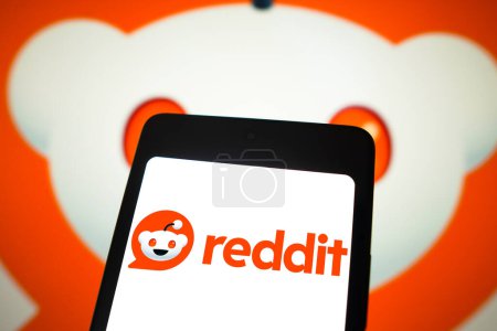 Photo for February 24, 2024, Brazil. In this photo illustration, the Reddit logo is displayed on a smartphone screen and in the background - Royalty Free Image