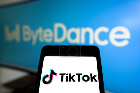 Photo for March 14, 2024, Brazil. In this photo illustration, the TikTok logo is displayed on a smartphone screen with the logo ByteDance in the background - Royalty Free Image