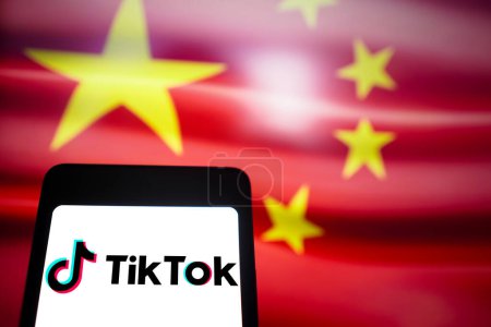 Photo for March 14, 2024, Brazil. In this photo illustration, the TikTok logo is displayed on a smartphone screen with the flag China in the background - Royalty Free Image