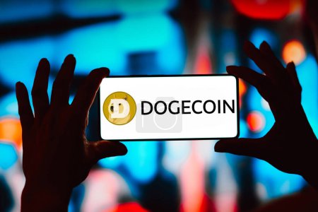 Photo for March 29, 2024, Brazil. In this photo illustration, the Dogecoin logo is displayed on a smartphone screen - Royalty Free Image