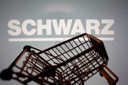 Photo for March 31, 2024, Brazil. In this photo illustration, the Schwarz Group logo seen displayed on a smartphone along with a shopping cart - Royalty Free Image
