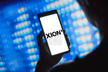 Photo for April 2, 2024, Brazil. In this photo illustration, the XION logo is displayed on a smartphone screen - Royalty Free Image