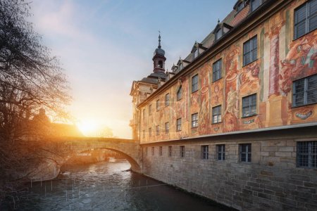 Photo for Side view of Old Town Hall (Altes Rathaus) with frescoes and bridge over Regnitz River at sunset - Bamberg, Bavaria, Germany - Royalty Free Image