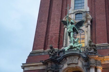 Photo for St. Michael Victory over the Devil Sculpture at St. Michael Church Facade - Hamburg, Germany - Royalty Free Image