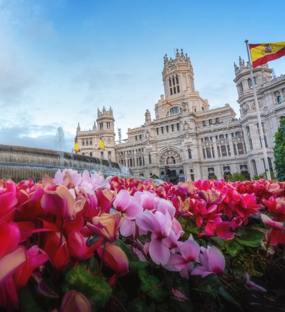 Photo for Cibeles Palace with beautiful pink flowers at Plaza de Cibeles - Madrid, Spain - Royalty Free Image