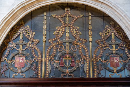 Photo for Toledo, Spain - Mar 27, 2019: Decoration with Coat of Arms above Door at Monastery of San Juan de los Reyes Church - Toledo, Spain - Royalty Free Image