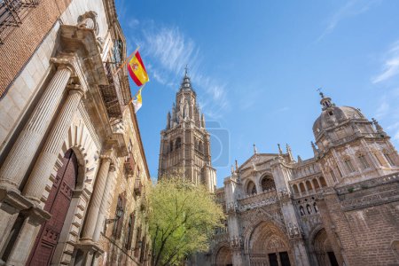 Photo for Toledo Cathedral Facade and Flag of Spain - Toledo, Spain - Royalty Free Image