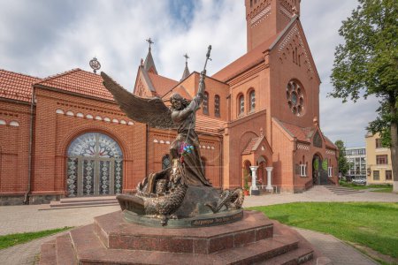 Photo for Minsk, Belarus - Jul 30, 2019: Statue of Archangel Michael slaying the Dragon in front of Church of Saints Simon and Helena - Minsk, Belarus - Royalty Free Image