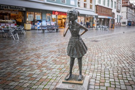 Photo for Hamelin, Germany - Jan 13, 2020: The Curious Girl Statue by Bernhard Kleinhans (Die Neugierige) - Hamelin, Germany - Royalty Free Image