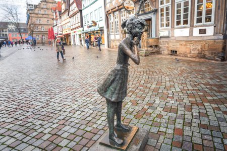 Photo for Hamelin, Germany - Jan 13, 2020: The Curious Girl Statue by Bernhard Kleinhans (Die Neugierige) - Hamelin, Germany - Royalty Free Image