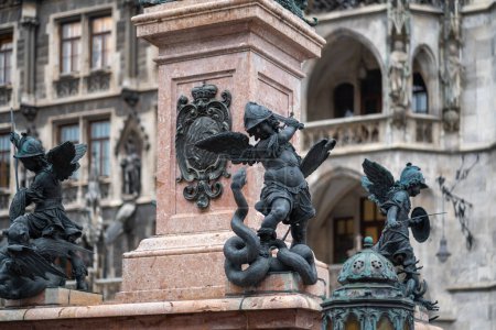 Photo for Munich, Germany - Oct 30, 2019: Putto fighting a serpent representing heresy - Mariensaule Sculpture at Marienplatz Square - Munich, Bavaria, Germany - Royalty Free Image